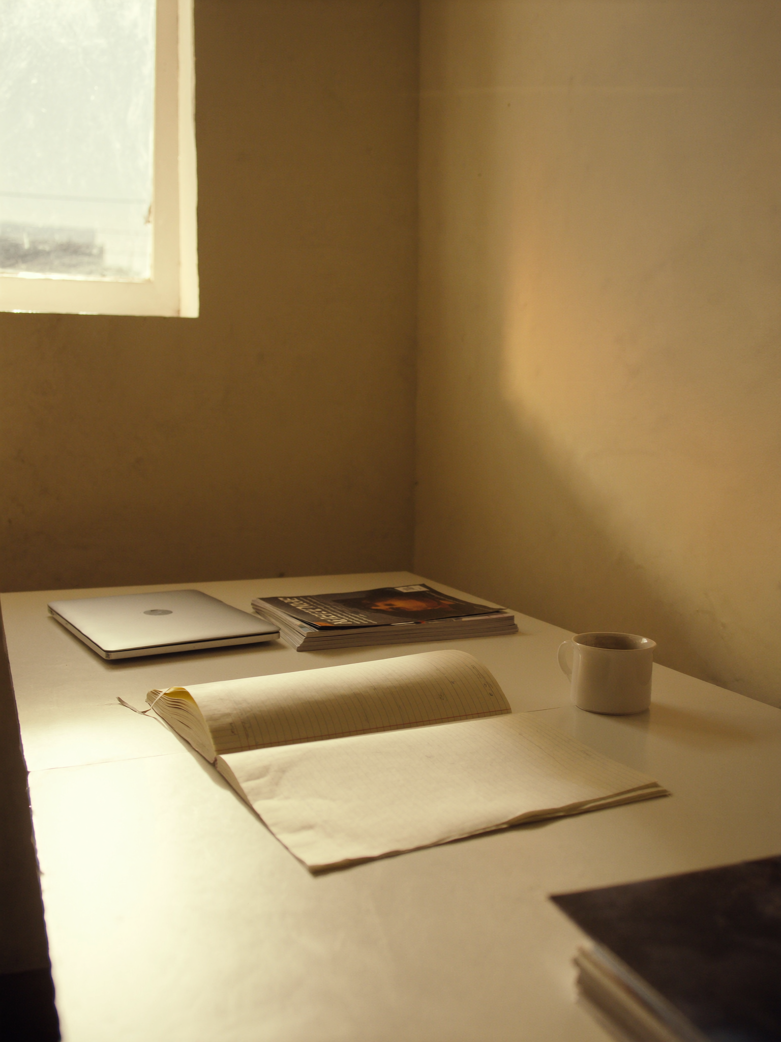 Generated atmosphere: a meeting table in warm light. Not a photograph of Gift Lubele.