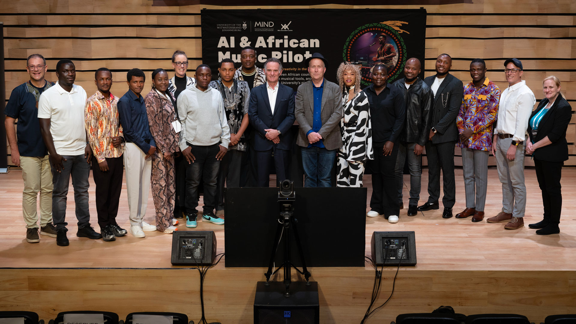 Gift Lubele with colleagues on stage at the Wits AI and African Music Pilot. Photograph.