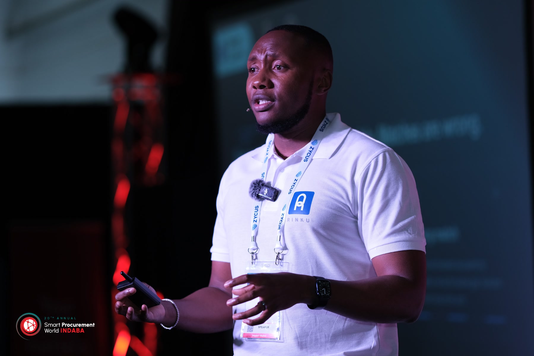 Gift Lubele speaking at Smart Procurement World Indaba, speaker badge and Rinku polo visible. Photograph.